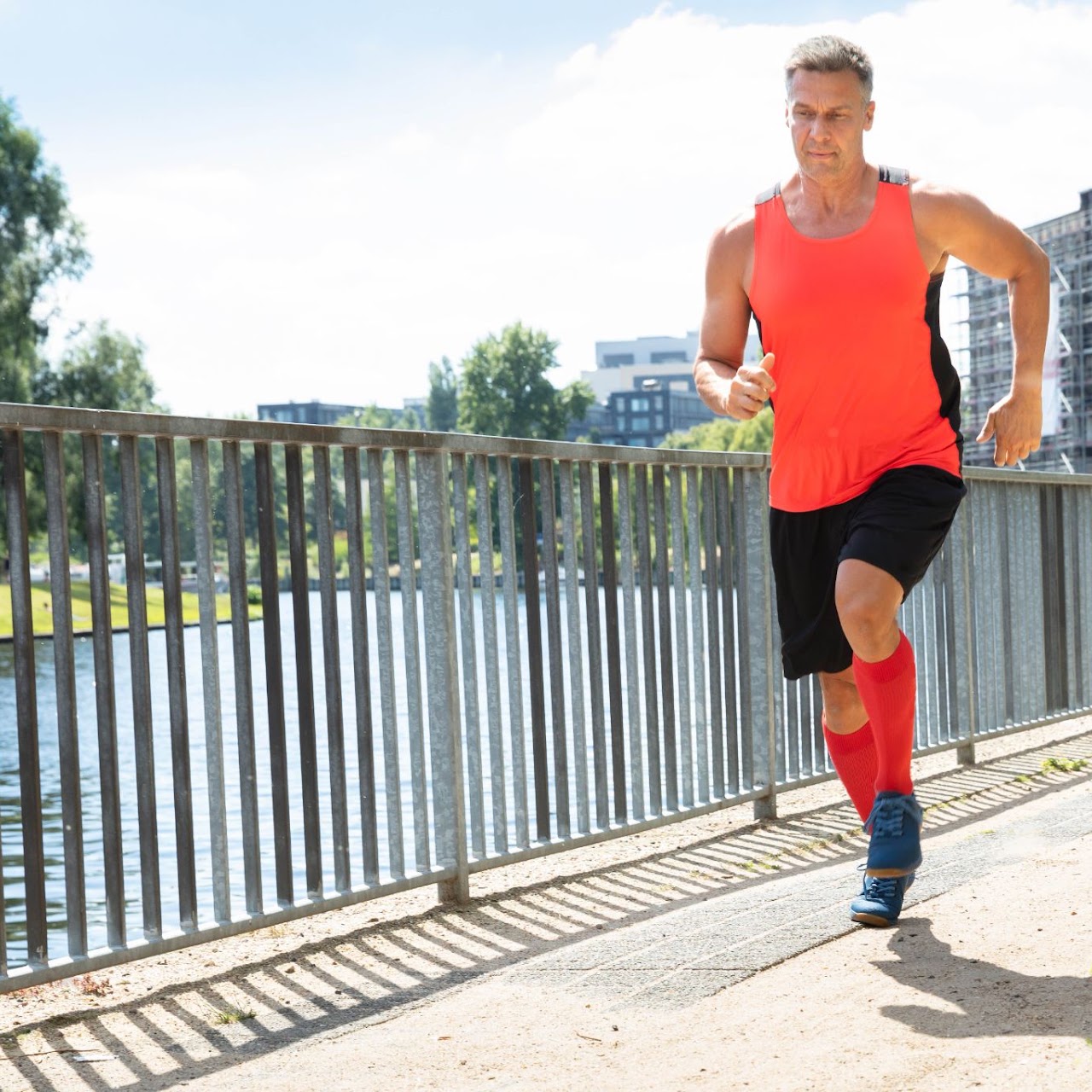 Runner on a riverside path wearing compression socks